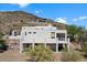 Aerial view of house showcasing unique architectural style and hillside location at 43908 N 10Th St, New River, AZ 85087