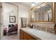 Clean bathroom with wood vanity, tile accents, and large mirror at 43908 N 10Th St, New River, AZ 85087