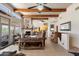 Open living room showcasing a rustic design with wood accents and expansive windows at 43908 N 10Th St, New River, AZ 85087