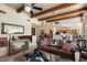 Open living room with leather couches and a view into the kitchen at 43908 N 10Th St, New River, AZ 85087