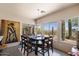 Charming dining room featuring large windows, a rustic table and scenic views at 43908 N 10Th St, New River, AZ 85087