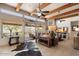 Spacious living room with wood beams, fireplace, and large windows offering scenic views at 43908 N 10Th St, New River, AZ 85087