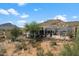 Desert landscape with a house, showcasing mountain views and surrounding nature at 43908 N 10Th St, New River, AZ 85087