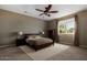 Spacious bedroom with carpeted floor, large window, and ceiling fan at 239 W Kristal Way, Phoenix, AZ 85027