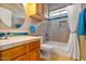 Clean bathroom with shower/tub combo, wood cabinets and tile flooring at 1402 E Coral Cove Dr, Gilbert, AZ 85234