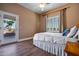 Bright bedroom with double bed, wood flooring, and access to private balcony at 1402 E Coral Cove Dr, Gilbert, AZ 85234