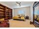 Well-lit bedroom with large bookcase and full-length mirror at 1402 E Coral Cove Dr, Gilbert, AZ 85234