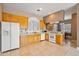 Well-equipped kitchen with wood cabinets and white appliances at 1402 E Coral Cove Dr, Gilbert, AZ 85234
