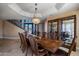 Formal dining room with a large wood table and chandelier, near staircase at 1402 E Coral Cove Dr, Gilbert, AZ 85234