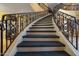 Grand curved staircase with ornate metal railing at 1402 E Coral Cove Dr, Gilbert, AZ 85234