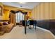 Music room with a grand piano and comfortable seating at 1402 E Coral Cove Dr, Gilbert, AZ 85234