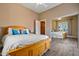 Bedroom with wood bed, plenty of light and mirrored closet doors at 1402 E Coral Cove Dr, Gilbert, AZ 85234