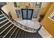 Elegant curved staircase with wrought iron railing in a grand foyer at 1402 E Coral Cove Dr, Gilbert, AZ 85234