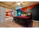 Basement bedroom with a king-size bed and an accent wall at 1402 E Coral Cove Dr, Gilbert, AZ 85234
