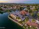 Waterfront property showcasing a large home and beautiful landscaping at 1402 E Coral Cove Dr, Gilbert, AZ 85234