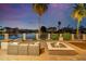 Evening view of patio with fire pit and seating area at 1402 E Coral Cove Dr, Gilbert, AZ 85234