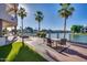 Relaxing patio overlooking the lake with seating area and fire pit at 1402 E Coral Cove Dr, Gilbert, AZ 85234