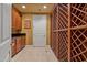 Walk-in wine cellar with custom wooden racks and cabinetry at 1402 E Coral Cove Dr, Gilbert, AZ 85234