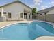 Inviting backyard pool with concrete decking and surrounding homes visible at 6447 W Escuda Rd, Glendale, AZ 85308