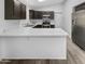 L-shaped kitchen with stainless steel appliances and an island at 6447 W Escuda Rd, Glendale, AZ 85308
