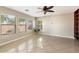 Living room features tile flooring, large windows, and built-in shelving at 11009 W Elm St, Phoenix, AZ 85037