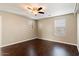 Well-lit bedroom with dark wood floors and a ceiling fan at 11009 W Elm St, Phoenix, AZ 85037