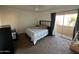 Bright bedroom with a double bed, access to a balcony, and plenty of natural light at 6337 N 49Th Ave, Glendale, AZ 85301