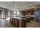 Gourmet kitchen boasts granite countertops and dark wood cabinetry at 38718 N 24Th Ave, Phoenix, AZ 85086