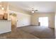 Spacious living room with tile and carpet flooring, and sliding glass doors at 10649 W Monte Vista Rd, Avondale, AZ 85392