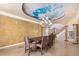 Elegant dining room with a painted ceiling and chandelier at 21639 N 55Th Dr, Glendale, AZ 85308