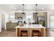 Modern kitchen with a large island and stainless steel appliances at 900 N Windy Meadow Ln, Maricopa, AZ 85139