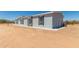 House side view showcasing light gray siding, windows, and backyard at 900 N Windy Meadow Ln, Maricopa, AZ 85139