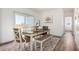 Dining area featuring a wooden table, chairs, bench, and neutral decor at 900 N Windy Meadow Ln, Maricopa, AZ 85139