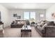 Living room with two sofas, coffee table, and neutral decor at 900 N Windy Meadow Ln, Maricopa, AZ 85139
