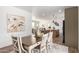 Bright dining area with farmhouse table and view into the kitchen at 900 N Windy Meadow Ln, Maricopa, AZ 85139