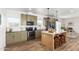 Modern kitchen with green cabinets, island, and stainless steel appliances at 900 N Windy Meadow Ln, Maricopa, AZ 85139