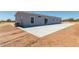 Rear view of a manufactured home showcasing a large concrete patio at 900 N Windy Meadow Ln, Maricopa, AZ 85139