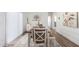 Dining area with wooden table, chairs, bench, and neutral color scheme at 900 N Windy Meadow Ln, Maricopa, AZ 85139