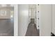 Bright hallway with grey wood-look flooring and doors to other rooms at 3368 W Judd Rd, San Tan Valley, AZ 85144