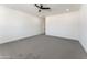 Spacious bedroom with ceiling fan and grey carpet at 3368 W Judd Rd, San Tan Valley, AZ 85144