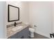 Clean bathroom with granite countertop and gray cabinets at 3368 W Judd Rd, San Tan Valley, AZ 85144