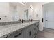 Modern bathroom with double vanity, granite countertop and grey cabinets at 3368 W Judd Rd, San Tan Valley, AZ 85144