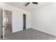 Spacious bedroom with ceiling fan, grey carpet and access to hallway at 3368 W Judd Rd, San Tan Valley, AZ 85144