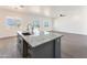 Modern kitchen with gray island and granite countertops at 3368 W Judd Rd, San Tan Valley, AZ 85144