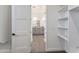Spacious walk-in closet with built-in shelves, adjacent to bathroom at 3368 W Judd Rd, San Tan Valley, AZ 85144