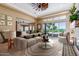 Spacious living room with golf course views and a fireplace at 16401 W Monterey Way, Goodyear, AZ 85395