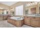 Elegant bathroom with soaking tub, double vanity, and tile flooring at 16401 W Monterey Way, Goodyear, AZ 85395