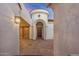 Elegant entryway with arched doorway and a courtyard at 16401 W Monterey Way, Goodyear, AZ 85395