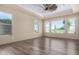 Bedroom with large windows offering a view and ceiling fan at 16401 W Monterey Way, Goodyear, AZ 85395