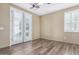 Bright bedroom with french doors and wood-look flooring at 16401 W Monterey Way, Goodyear, AZ 85395